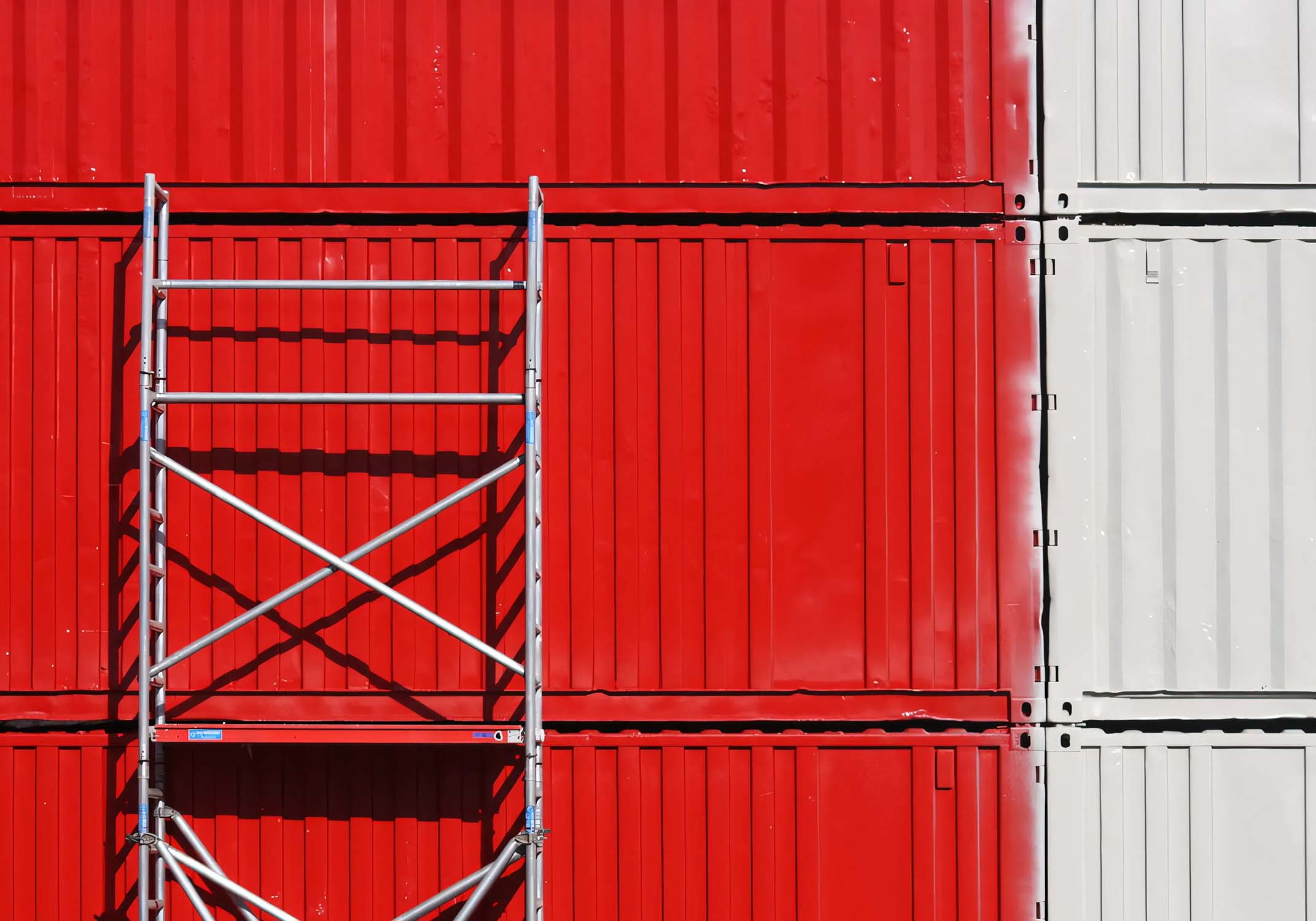Representative photo of red and white containers with scaffolding.